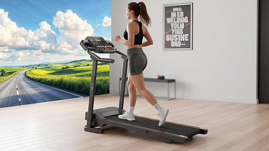 A person runs on a treadmill with a scenic road backdrop.