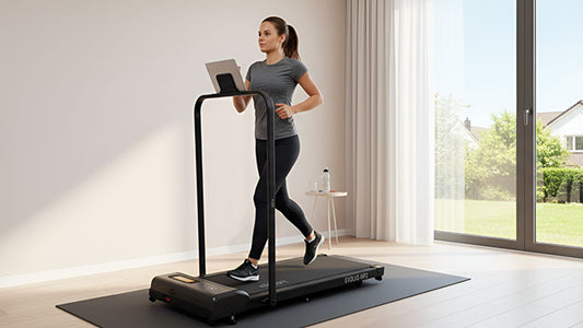 A person runs on a treadmill while looking at a tablet.