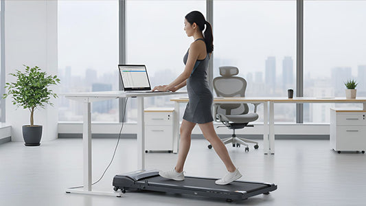 Person walks on treadmill desk while working on laptop.
